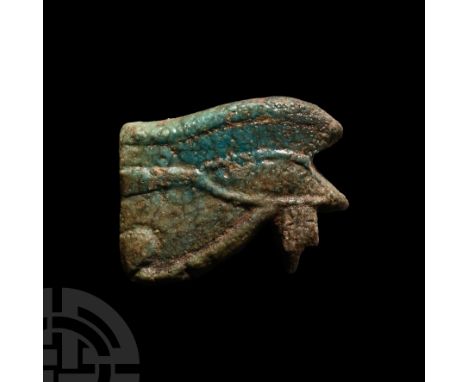 Late Period, 664-332 B.C. Deep green glazed composition amulet of the wedjat. See Andrews, C., Amulets of Ancient Egypt, Lond