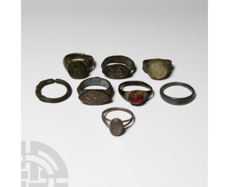 Circa 14th century AD and later. Comprising eight rings: two with glass intaglio; two with almond-shaped silvered bezels; one