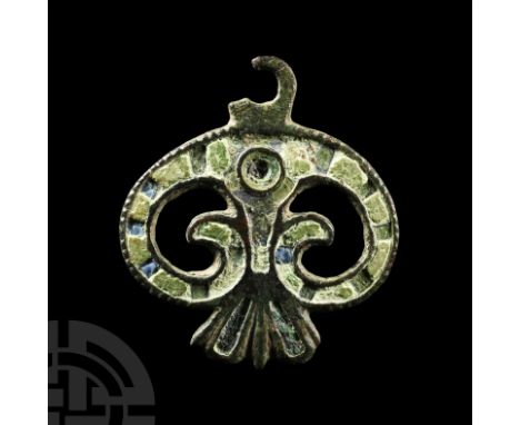 Late 1st-2nd century A.D. Formed as a volute scroll with flared tail; the body filled with alternating bands of (originally) 