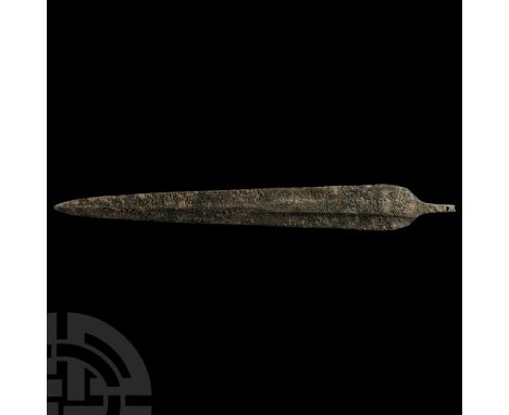 1st millennium B.C. With rounded shoulders and shallow square-sectioned mid-rib running to the blade tip; short tang with fas