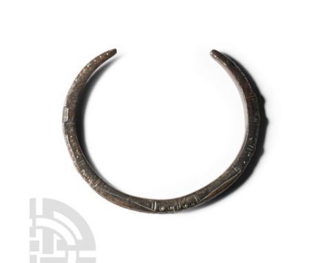 Circa 2nd-4th century A.D. Of penannular form, decorative panels with ring-and-dot and line designs separated by narrow decor