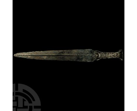 Circa 1000 B.C. The blade with a tapering profile, triangular in overall form, with slender shoulders, penannular guard with 