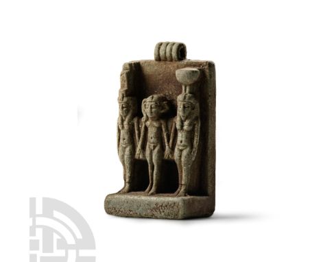 Late Period, 664-332 B.C. Olive-green glazed composition amulet with triad of deities: Isis and Nephthys wearing their usual 