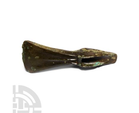 Middle Bronze Age, 1400-1150 B.C. Triangular flange on each side rising from the butt to the stop bar; below the septum, a ho