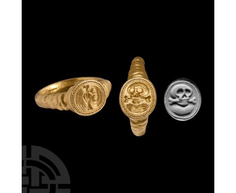 Circa 1600 A.D. Substantial gold hoop with ribbed shoulders and underside to the discoid bezel; incuse pelleted border enclos