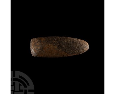 Neolithic, circa 7500-5300 B.C. Pecked and ground with a curved cutting edge and a narrow-rounded butt.  329 grams, 12.3 cm (
