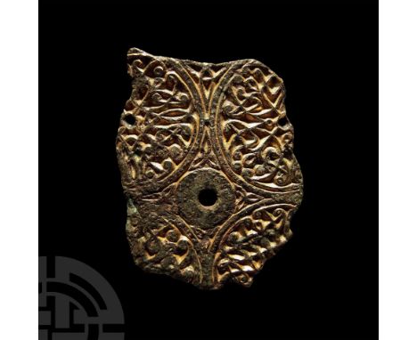 Later 8th-9th century A.D. Irregular fragment from a bronze casket mount formed with four discoid panels each filled with den