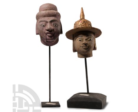 Circa 17th-18th century A.D. Two wooden figure heads mounted on custom-made display stands, one a puppet-head with movable mo