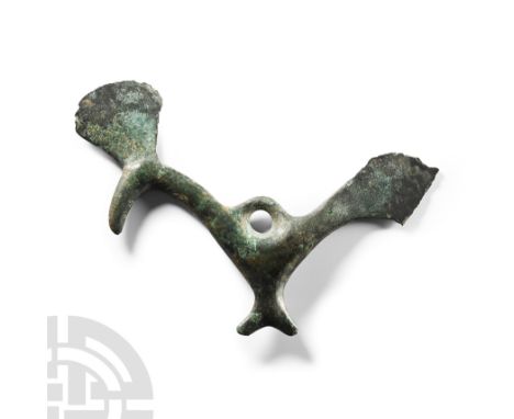 Circa 8th century B.C. Formed as a stylised bird with elongated tail and neck, chevron-shaped foot, hooked beak, domed eye, l