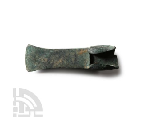 1400-1150 B.C. With leaf-shaped lateral flanges, mid-stop with deep ledge, flared blade with curved edge; butt absent. Cf. Sc