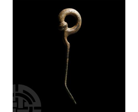 Late 1st millennium B.C. With tapering shank and integral ring with bulb finial; shank pierced below the junction with the bu