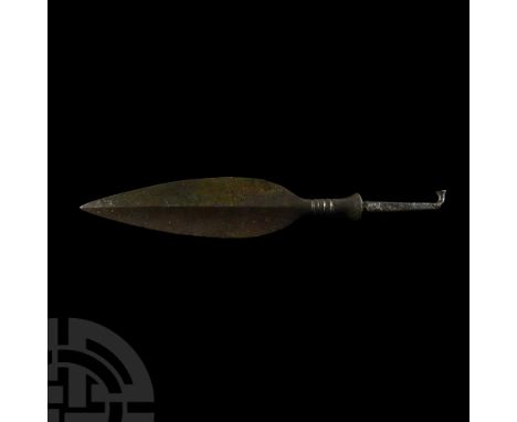 Early 2nd millennium B.C. Having ovate blade with central rib and slender shoulders, cylindrical short shaft marked by circul