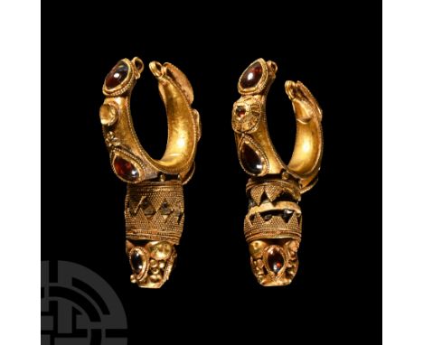 2nd-3rd century A.D. A hollow-formed hoop with lateral teardrop cells set with cabochon garnets and disc cells to the apex wi