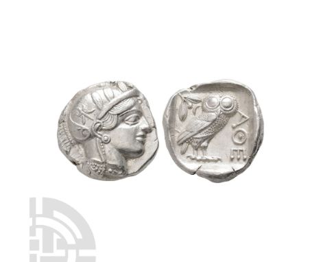 After 449 B.C. Obv: helmeted head of Athena right, full eye, wearing earring, necklace, and crested Attic helmet ornamented w