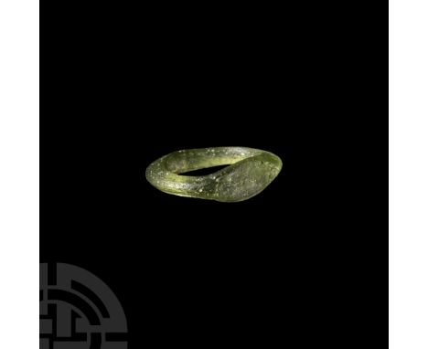1st-4th century A.D. In light green translucent glass, the hoop widening at the base, lozenge-shaped flat bezel  1.39 grams, 