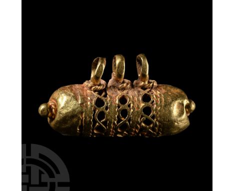 Circa 6th-8th century A.D. Of capsule form, possibly an amulet case; openwork filigree body and domed terminals with apex gra