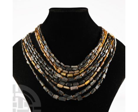 20th century A.D. or earlier. Comprising seven necklaces restrung from beads of drilled ancient glass bangle fragments.  120 