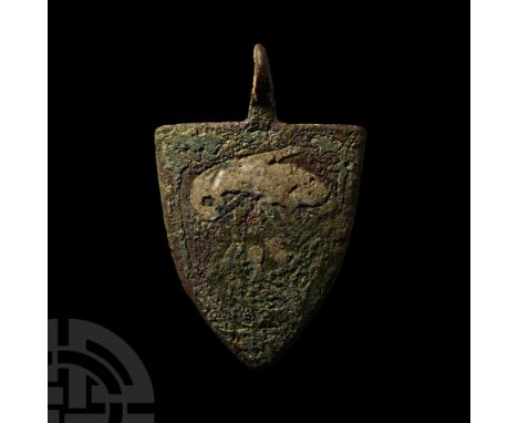 14th-15th century A.D. On a heater-shaped shield with pieced loop at the apex, a white enamelled bird facing left, bending ov