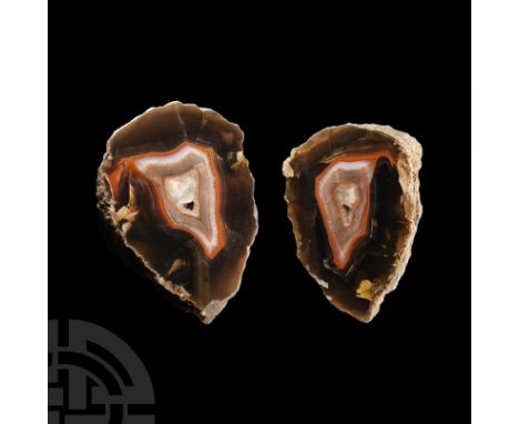 Comprising a boulder cut in two halves exposing the internal banding and a cavity of quartz crystals.  2.05 kg total, 13.8-14