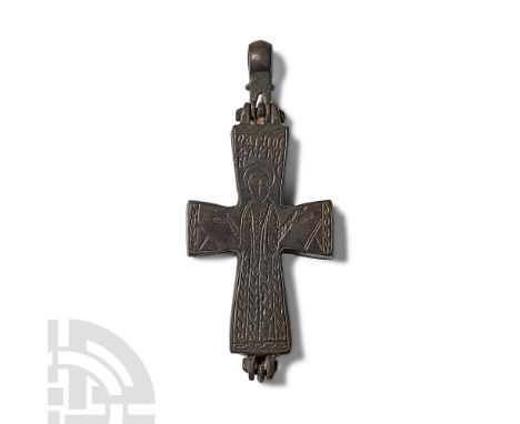 Circa 10th-12th century A.D. or later. Articulated enkolpion with loop; low-relief robed figure to each face in orans pose wi