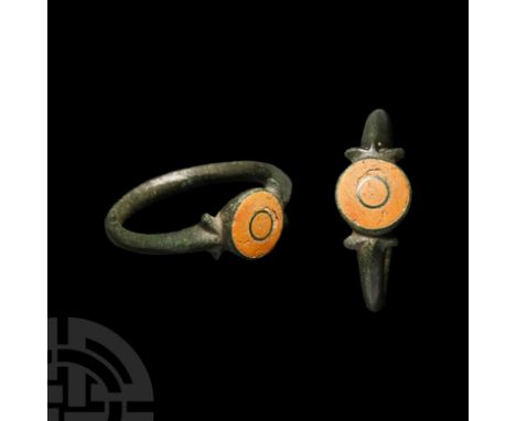 3rd-4th century A.D. With spurs to the shoulders, domed bezel with central roundel, enamel fill.  2.97 grams, 21.66 mm overal
