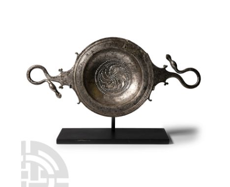 4th-3rd century B.C. Composed of a shallow bowl and broad flange rim, two integral scalloped handles with scrolled flourishes