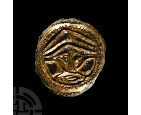 5th-6th century A.D. Class Ai; broad flange rim and circular frame enclosing a facing male mask with helmet detailing; pin-lu