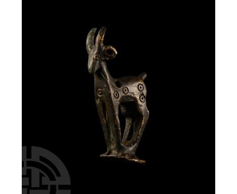 1st millennium B.C. Standing on a D-shaped base with perforations to the outer edge, ring-and-dot motifs to the flanks, pierc