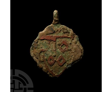 14th-15th century A.D. On a quatrefoil-shaped shield with pierced loop at the apex, remains of red enamel heater-shaped shiel