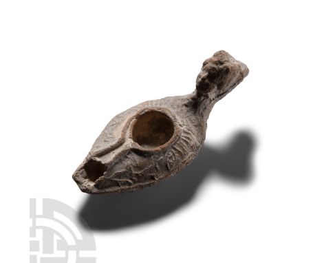 5th-8th century A.D. With a large sub circular filling hole and a narrow channel running towards the nozzle; stylised animal 