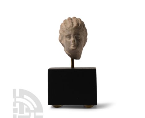Circa 4th-2nd century B.C. With hair divided in vertical arrangements, bound on the back by a fillet, delicate rendering of m