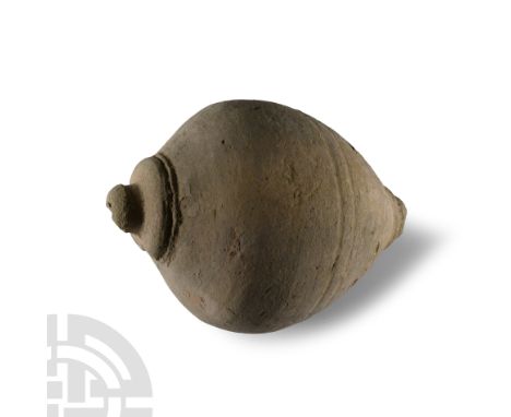 Circa 11th-14th century A.D. With a piriform body and domed mouth with two indented lines decorating the mid section; intende