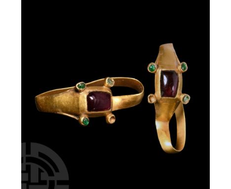 1200-1400 A.D. With a slender D-section hoop, bevelled rectangular cell set with a garnet cabochon; satellite settings at the