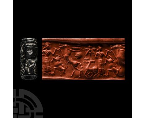 2nd-1st millennium B.C. Polished haematite cylinder with incuse frieze depicting a standing profile human figure in flounced 