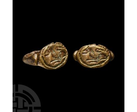 Circa 3rd-4th century A.D. With D-section shoulders flanking the ellipsoid plaque, incuse crouching beast in a pelletted bord