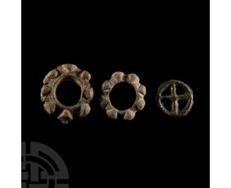 Late 1st millennium B.C. Three Eastern Celtic or Gaulish cast wheels; two with eight-knops and one four-spoked type.  16.6 gr