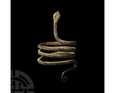 Circa 1st century B.C. With D-section narrow coiled band with stylised scale detailing, raised head and tightly coiled tip of