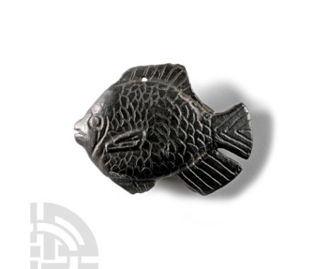 1st millennium B.C. Modelled in the round with incised scale detailing, annular eyes and open slit mouth; pierced through the