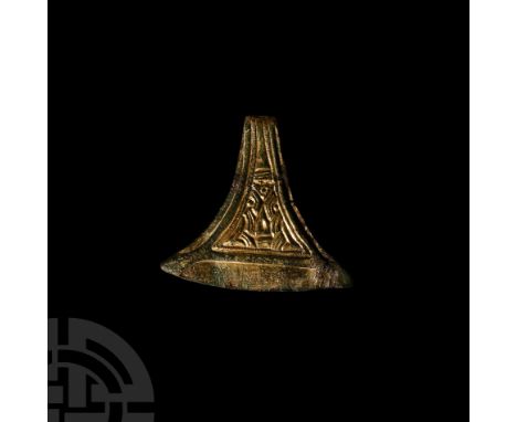 6th-7th century A.D. Formed with a pelta-shaped body, two attachment studs to the reverse, reserved border with raised triang