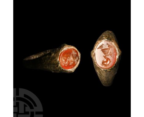 Circa 1st-2nd century A.D. With shoulders tapering towards the plaque and two lateral knops, inset carnelian intaglio of a fl