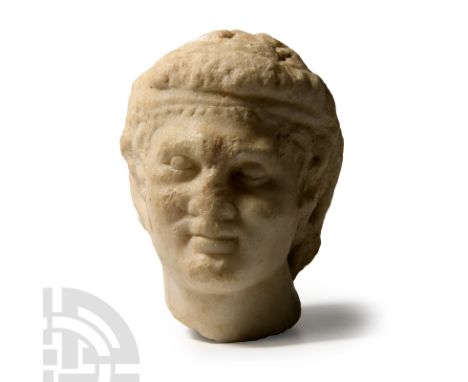 1st-3rd century A.D. Of Praxitelic type with fillet to the brow, tousled hair and rounded facial features with stern expressi