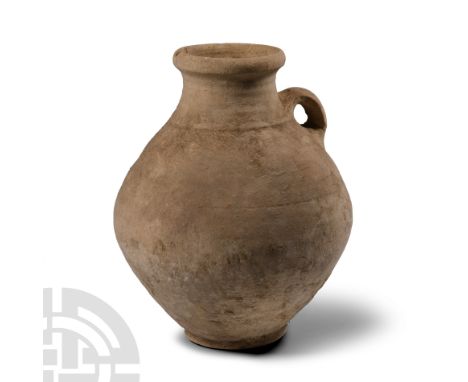1st-4th century A.D. With basal ring, piriform body, broad mouth with applied rim, single loop handle to the shoulder.  2.58 
