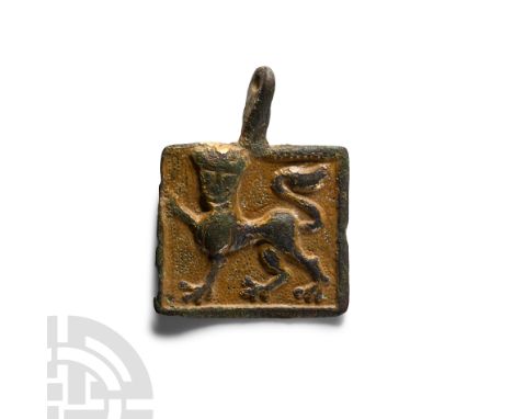 Circa 14th century A.D. Rectangular pendant with pelletted border, reserved repoussé crowned lion passant gardant on a keyed 