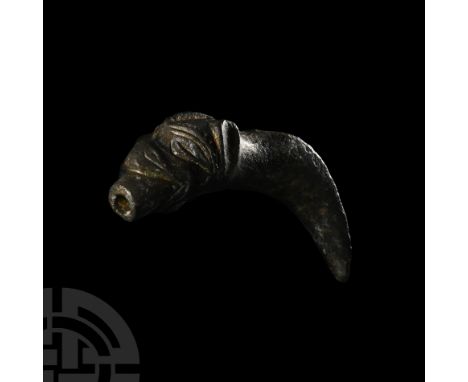 14th-15th century A.D. With stylised detailing, mouth closed around a round-section spout, curved round-section neck with sec