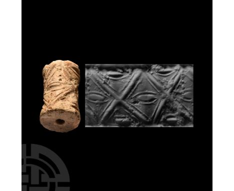 Circa 3rd millennium B.C. Cotton-reel type with incised 'eye' and saltire motifs. Cf. Teissier, B., Ancient Near Eastern Cyli