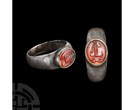 1st century A.D. Ellipsoid cell to the bezel, inset carnelian gemstone with intaglio Isis standing by the curved prow of a bo