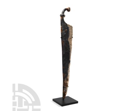 1st century B.C.-1st century A.D. Featuring a gently curved single-edged iron blade and one-sided fuller, curved handle with 