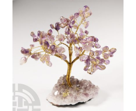 On an amethyst geode matrix; the metal branches tipped with polished light-coloured amethyst pebbles.  517 grams, 14 cm high 