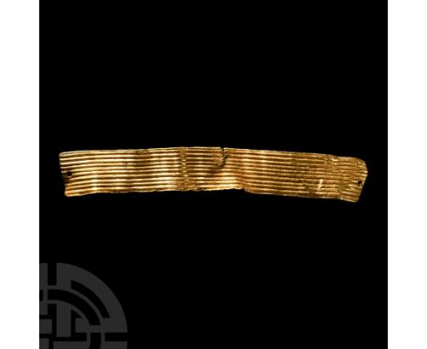 Circa 2350-800 B.C. Rectangular sheet-gold ribbon, plaque or cordon with reeded outer face and plain reverse, mounting hole t