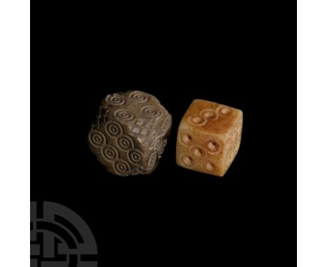 1st-4th century A.D. Comprising: one with ring-and-dot markings disposed 1:6, 2:5, 3:4; the other a cornerless cuboid with ha